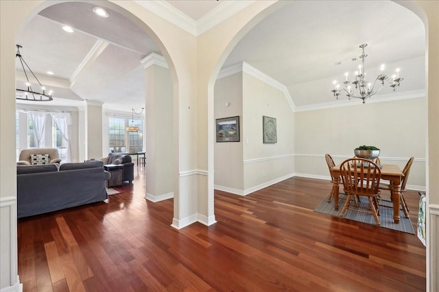 interior space featuring baseboards, a chandelier, and wood finished floors
