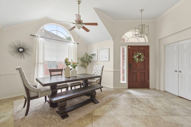 dining space with light tile patterned floors, baseboards, ornamental molding, and ceiling fan with notable chandelier
