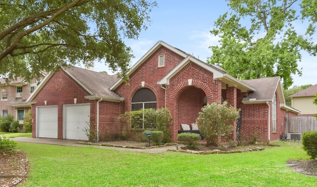 traditional-style house featuring brick siding, an attached garage, and a front yard