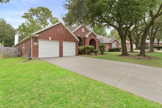 view of front of home with driveway, a front lawn, and brick siding