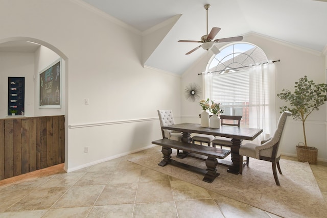 dining area featuring arched walkways, a ceiling fan, vaulted ceiling, and light tile patterned floors