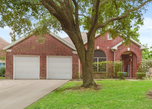 traditional-style house featuring brick siding, a front lawn, an attached garage, and driveway