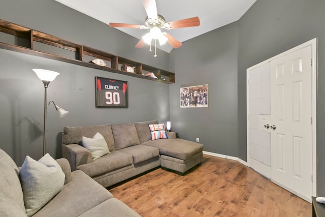 living room with baseboards, ceiling fan, high vaulted ceiling, and wood finished floors