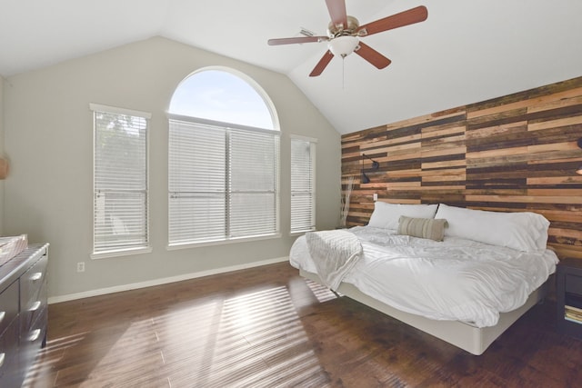 bedroom featuring wood walls, ceiling fan, vaulted ceiling, and dark wood-style floors
