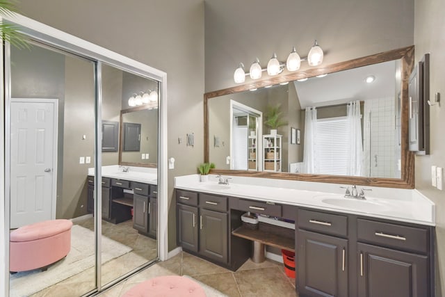 bathroom with a sink, tile patterned flooring, and double vanity