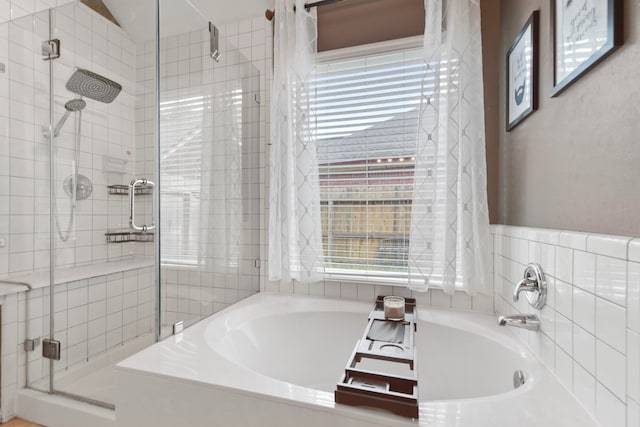 bathroom featuring a garden tub and a stall shower