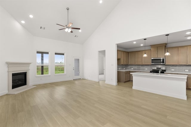 kitchen with visible vents, open floor plan, light countertops, and stainless steel appliances
