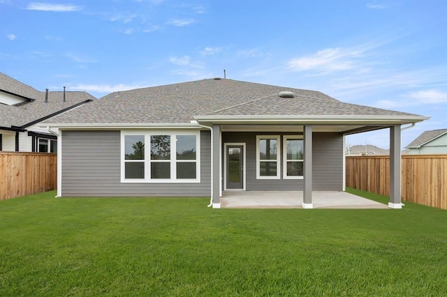 back of house with a yard, a fenced backyard, and a patio area