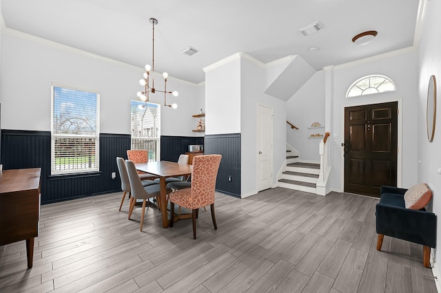 dining room featuring visible vents, stairway, and a wainscoted wall