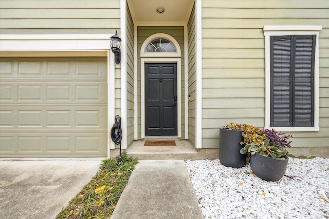 view of exterior entry featuring an attached garage