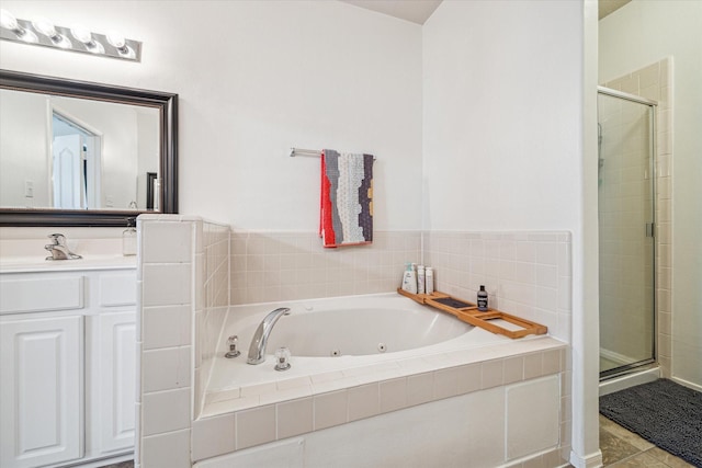 bathroom featuring a jetted tub, vanity, tile patterned flooring, and a shower stall