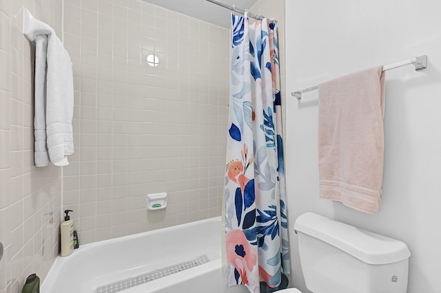 full bath with shower / bath combo with shower curtain and toilet