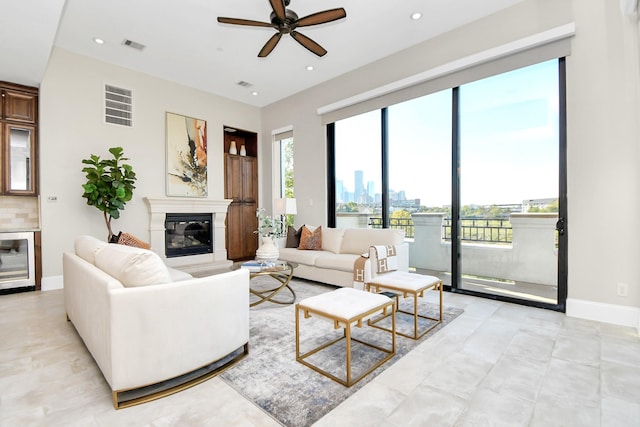 631 N Live Oak St, Houston, TX 77003 - living room with ceiling fan, a glass covered fireplace, beverage cooler, baseboards, and a skyline view