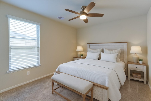 bedroom with baseboards, ceiling fan, visible vents, and carpet floors