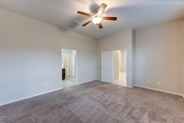unfurnished bedroom with a ceiling fan, baseboards, visible vents, connected bathroom, and light carpet