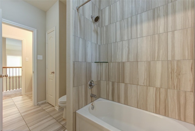 bathroom with toilet, baseboards, tile patterned flooring, and bathtub / shower combination