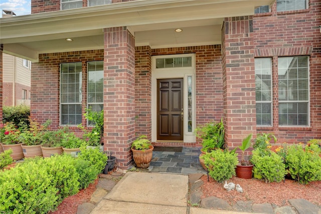 entrance to property featuring brick siding