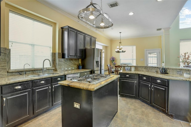 kitchen featuring crown molding, a sink, light tile patterned floors, a kitchen island, and visible vents