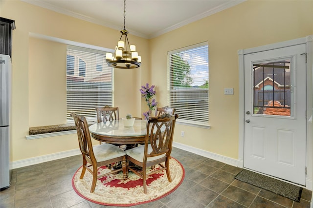 dining area featuring an inviting chandelier, baseboards, and crown molding