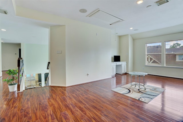 unfurnished living room featuring visible vents, attic access, wood finished floors, and recessed lighting