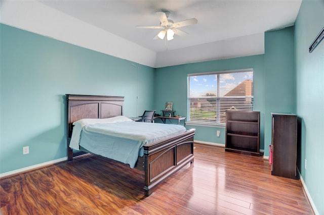 bedroom with baseboards, ceiling fan, and wood finished floors