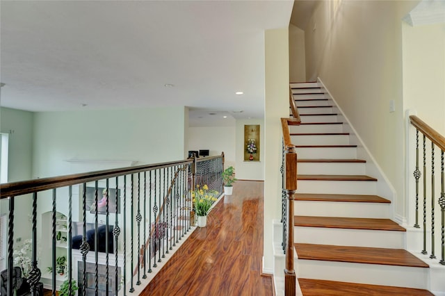 stairs featuring recessed lighting and wood finished floors