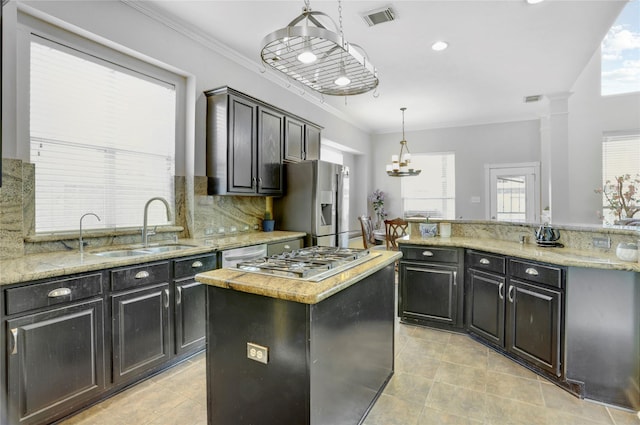 10007 Autumn Lake Trl, Pearland, TX 77584 - kitchen with a center island, a sink, light tile patterned floors, ornamental molding, and stainless steel appliances