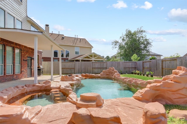 10007 Autumn Lake Trl, Pearland, TX 77584 - view of swimming pool featuring a patio, a fenced backyard, and area for grilling