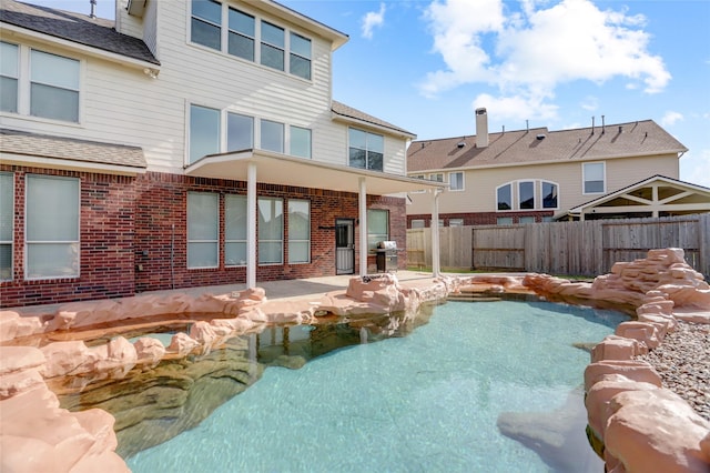 10007 Autumn Lake Trl, Pearland, TX 77584 - view of swimming pool with fence, a patio area, and grilling area