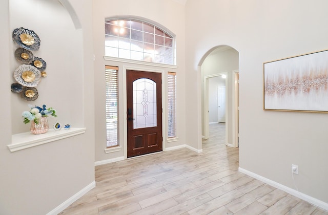 15027 Wildberry Creek Ct, Cypress, TX 77433 - foyer with arched walkways, baseboards, wood finished floors, and a high ceiling