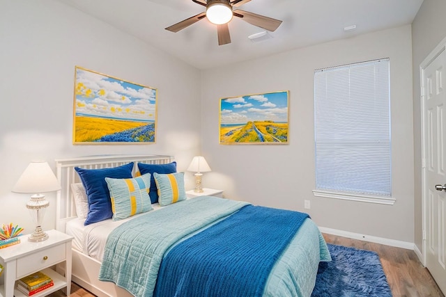 15027 Wildberry Creek Ct, Cypress, TX 77433 - bedroom with baseboards, a ceiling fan, and wood finished floors