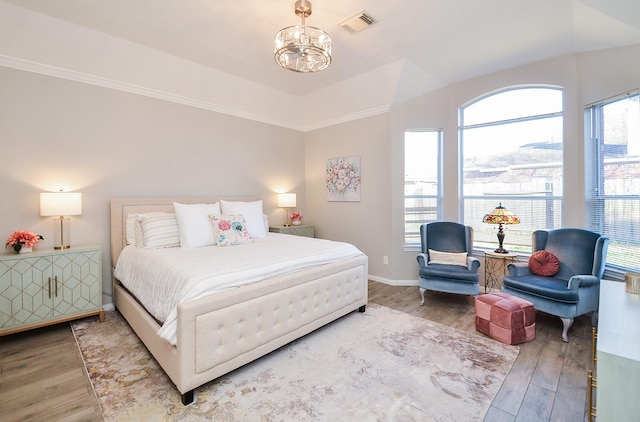 15027 Wildberry Creek Ct, Cypress, TX 77433 - bedroom with a notable chandelier, visible vents, and wood finished floors