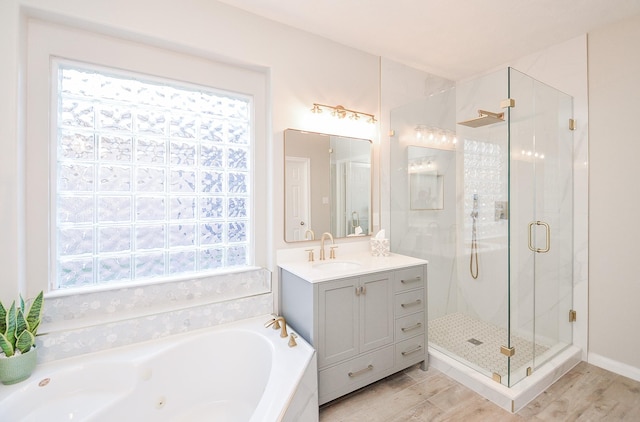 15027 Wildberry Creek Ct, Cypress, TX 77433 - bathroom featuring vanity, a stall shower, a tub with jets, and wood finished floors