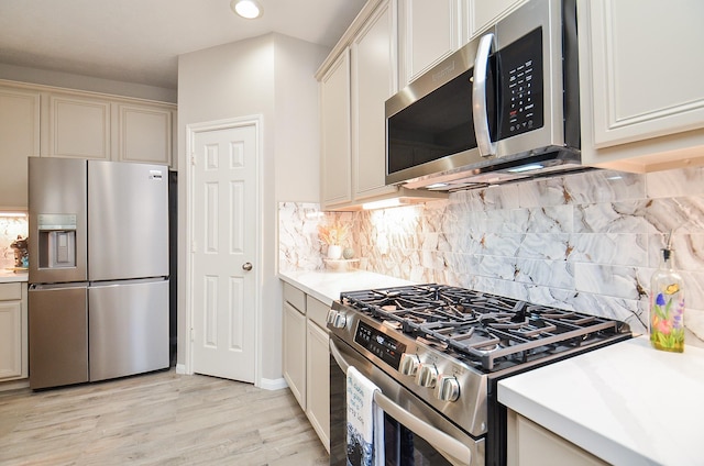 15027 Wildberry Creek Ct, Cypress, TX 77433 - kitchen with light countertops, tasteful backsplash, stainless steel appliances, and light wood-type flooring