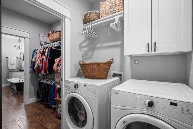 laundry area featuring washer and dryer, baseboards, dark wood-type flooring, and cabinet space