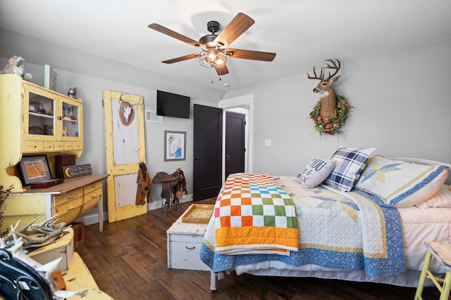 bedroom with a ceiling fan and dark wood-style floors