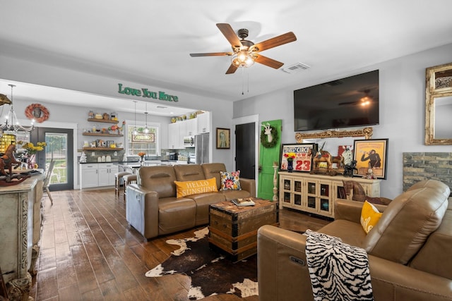 living area featuring ceiling fan, dark wood-style floors, and visible vents