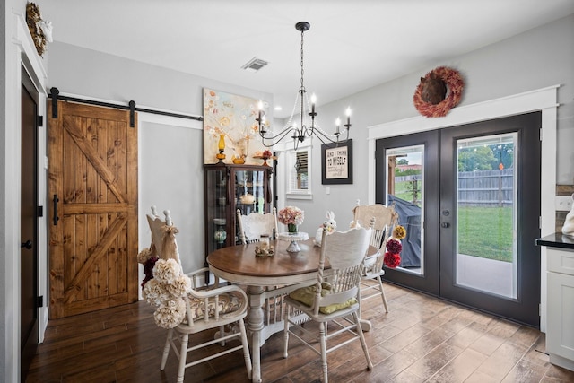 dining space with light wood-style floors, french doors, a chandelier, and visible vents