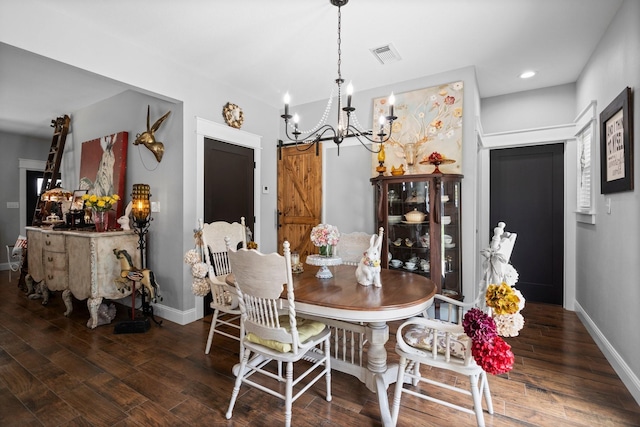 dining room featuring baseboards, wood finished floors, a notable chandelier, and visible vents