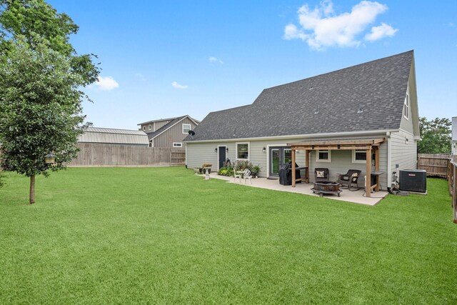 rear view of property featuring a lawn, central AC, a fenced backyard, and a patio area