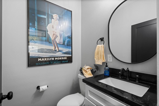 half bath with vanity and toilet