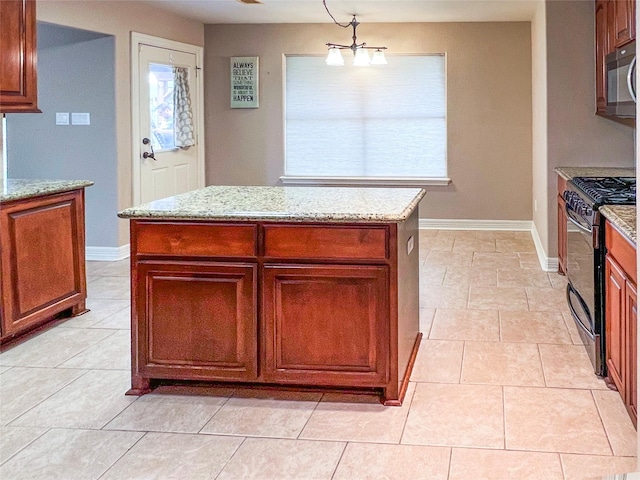 110 Hummingbird Ct, Richwood, TX 77566 - kitchen featuring a kitchen island, light stone countertops, baseboards, and black gas range
