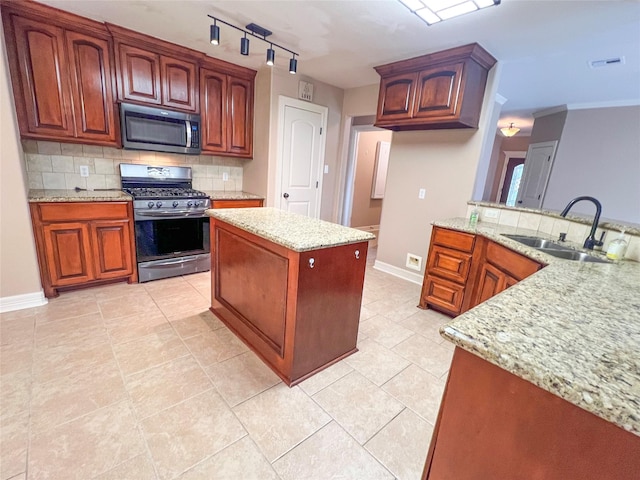110 Hummingbird Ct, Richwood, TX 77566 - kitchen featuring backsplash, appliances with stainless steel finishes, light stone countertops, a sink, and baseboards