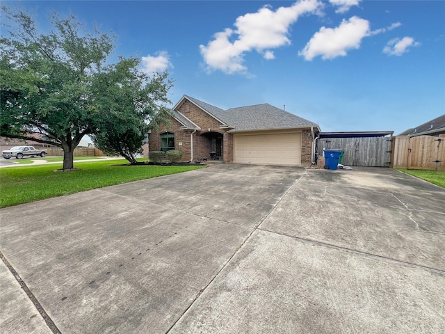 110 Hummingbird Ct, Richwood, TX 77566 - view of front facade with a garage, a front lawn, fence, brick siding, and concrete driveway