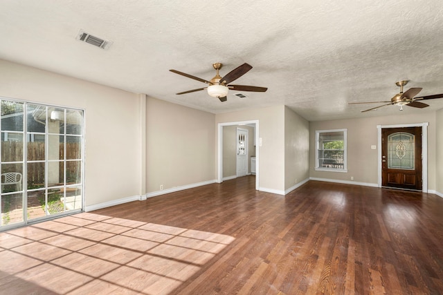 interior space featuring visible vents, baseboards, ceiling fan, and wood finished floors