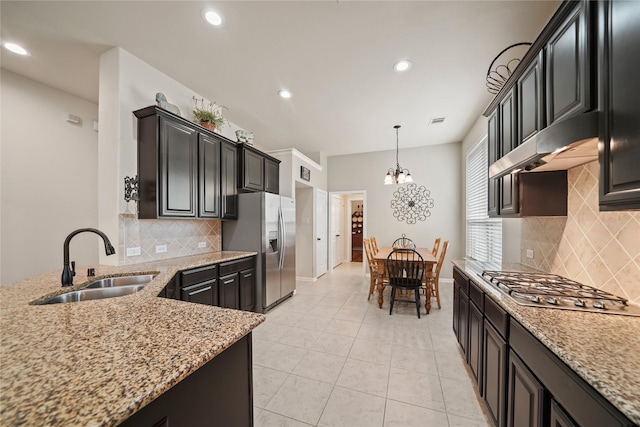 21023 Barrett Woods Dr, Richmond, TX 77407 - kitchen with appliances with stainless steel finishes, light stone counters, a sink, recessed lighting, and under cabinet range hood