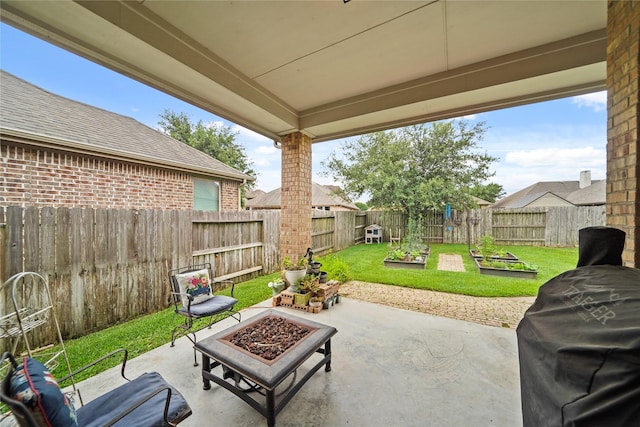 21023 Barrett Woods Dr, Richmond, TX 77407 - view of patio / terrace featuring a fenced backyard, a garden, and an outdoor fire pit