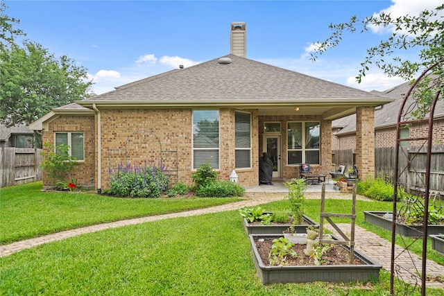 21023 Barrett Woods Dr, Richmond, TX 77407 - rear view of property with a lawn, fence, and a garden