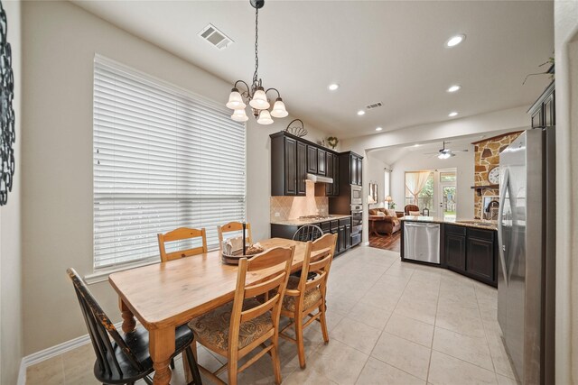 21023 Barrett Woods Dr, Richmond, TX 77407 - dining area featuring visible vents, recessed lighting, ceiling fan with notable chandelier, and light tile patterned floors