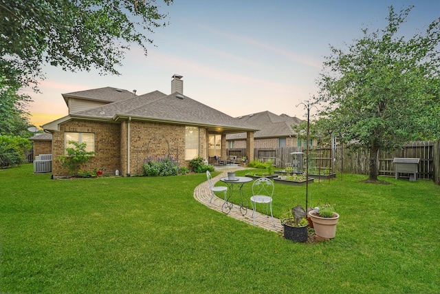 21023 Barrett Woods Dr, Richmond, TX 77407 - rear view of property with fence, a yard, a patio area, and brick siding